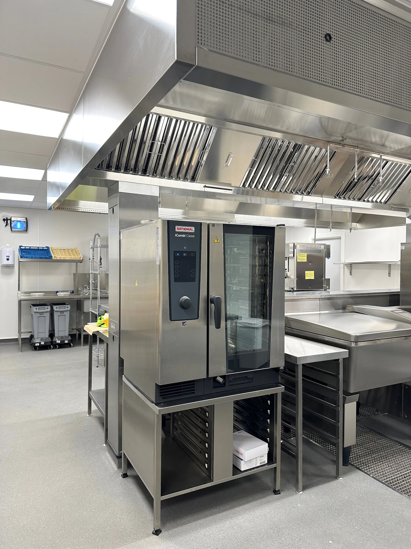 Commercial kitchen exhaust hood over stainless steel equipment