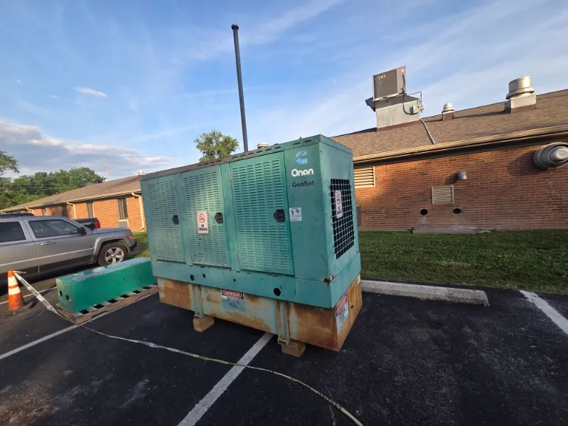 Commercial standby generator outside a brick building