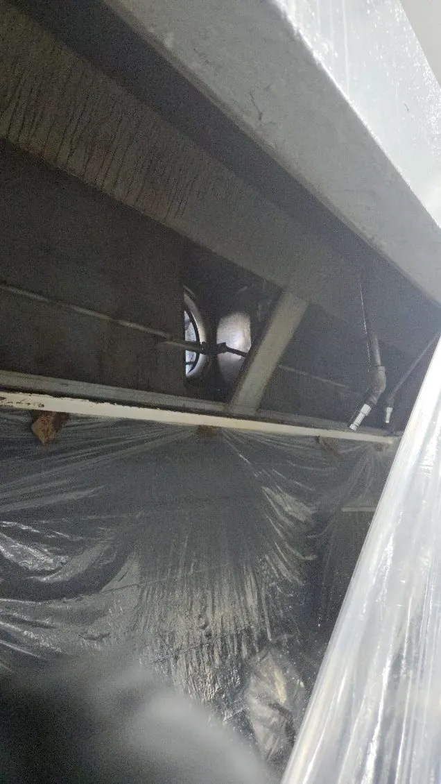 Inside a commercial kitchen hood after cleaning, exhaust fan visible